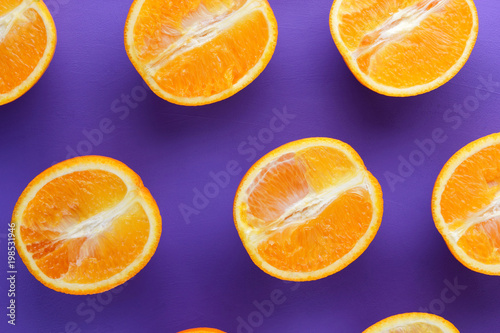 Sliced fruit oranges in checkered pattern on a purple background, symmetrically laid out citrus in pop art style, fruit pattern of halves of oranges, ultraviolet, minimalism