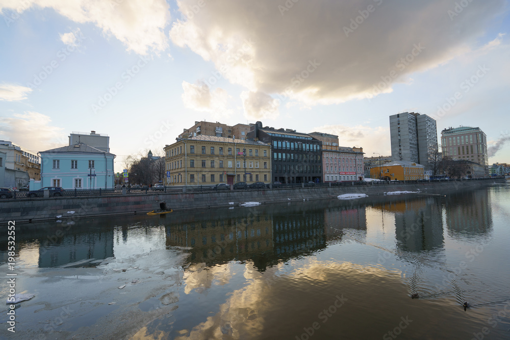 Fototapeta premium Spring Moscow image. The cloud is reflected in the water of the river