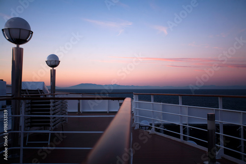 Beautiful colored sunset and dig luxury tourist liner in the sea photo