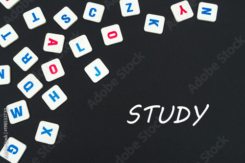 English colored square letters scattered on black background with text study