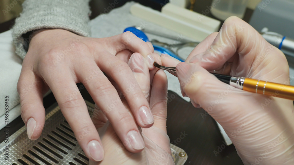 Cover gel with nail polish. Woman's hands at manicure procedures