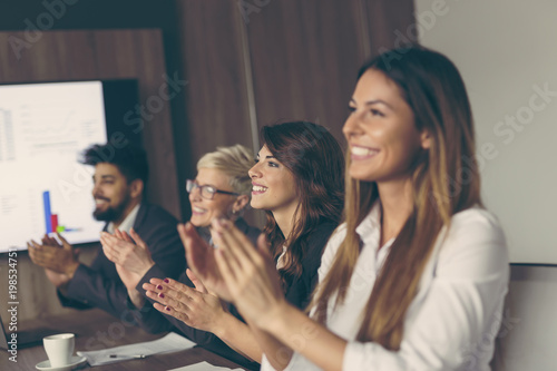 Business people applauding after successful presentation