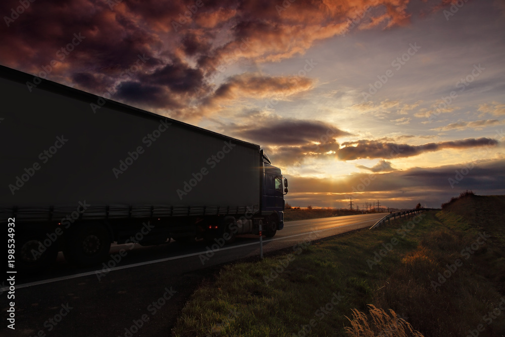 Truck transportation on the road at sunset Truck transportation on the road at sunset