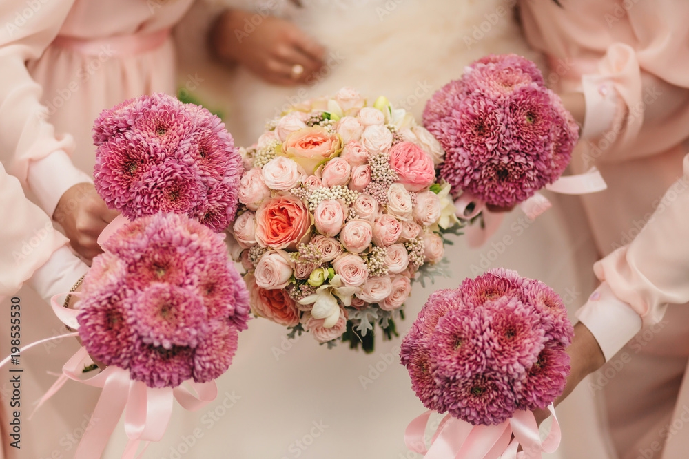 Wedding flowers, bride and bridesmaids holding their bouquets at ...