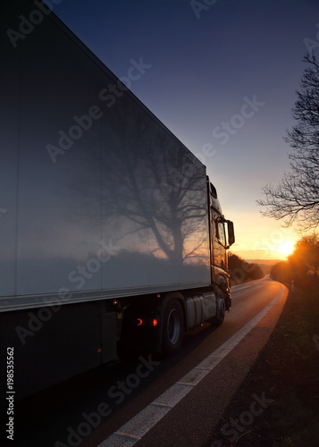 Truck transportation on the road at sunset