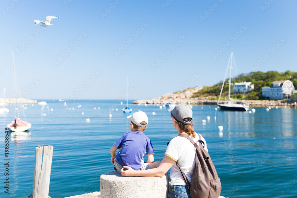 tourists on the pier admire the view of the sea. mother with a young son look at the sea harbor. Copy space for your text