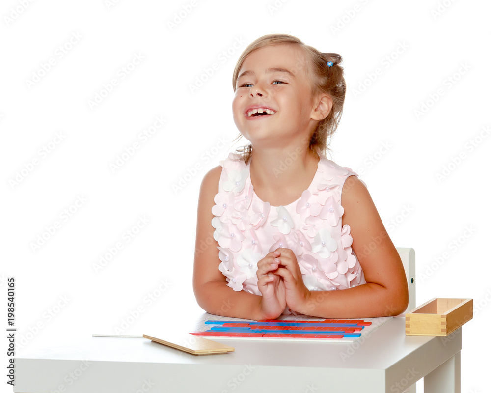 A little girl is studying Montessori stuff. A little girl is studying Montessori stuff.