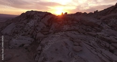 EPIC Beautiful sun through rocks fly over - Drone Aerial Video 4K Arizona, Utah, Moab desert, open plain, trail, adventure, discovery landscape, reveal, beautiful, prairie, sun reveal beautiful.