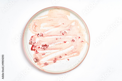 Top view of dirty plate with ice cream stains and fat
