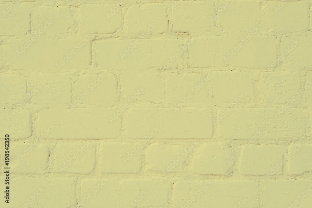 the surface of the brickwork is painted with yellow paint the surface of the brickwork is painted with yellow paint