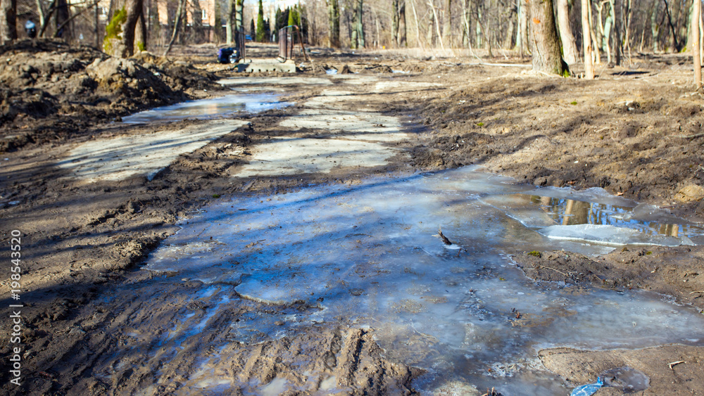 spring mud and puddles on the road spring mud and puddles on the road