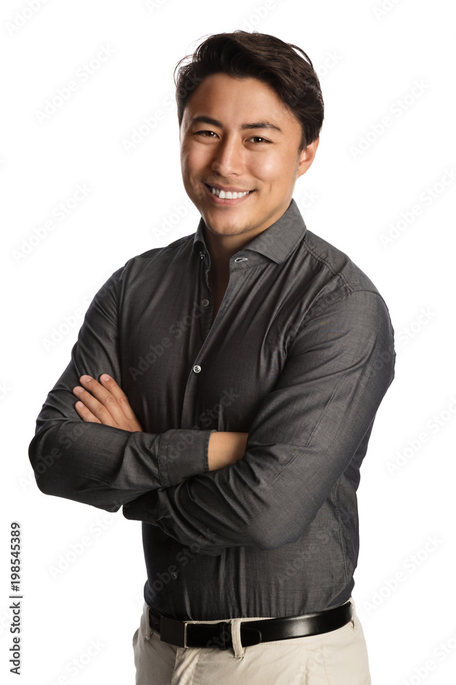 Handsome man in a grey shirt standing against a white background with a big smile on his face. Handsome man in a grey shirt standing against a white background with a big smile on his face.