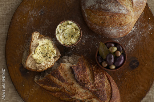 Close-up of artisan bread butter and olives
