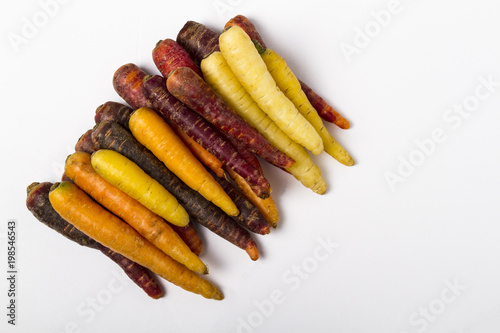 Multi-colored carrots on a white background
