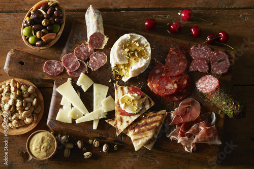 Overhead view of tapas ingredient placed randomly on cutting board