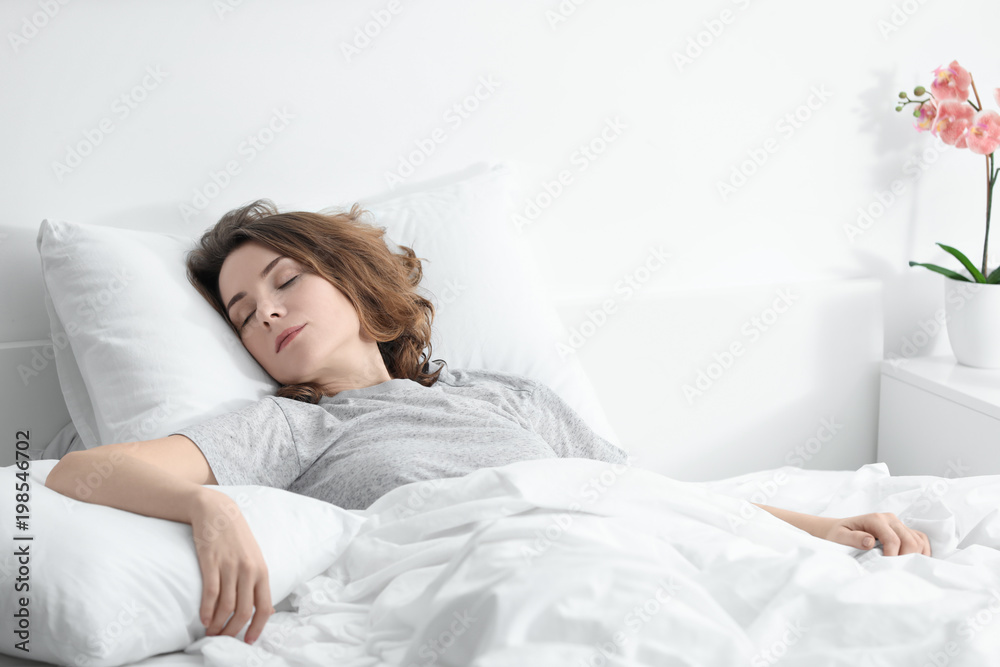 Woman sleeping in bed at home Woman sleeping in bed at home