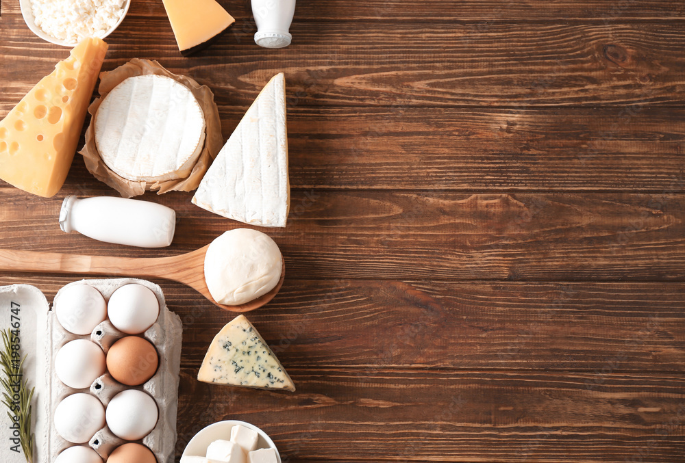 Fresh dairy products and eggs on wooden background Fresh dairy products and eggs on wooden background