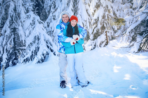 Happy couple at beautiful snowy resort. Winter vacation