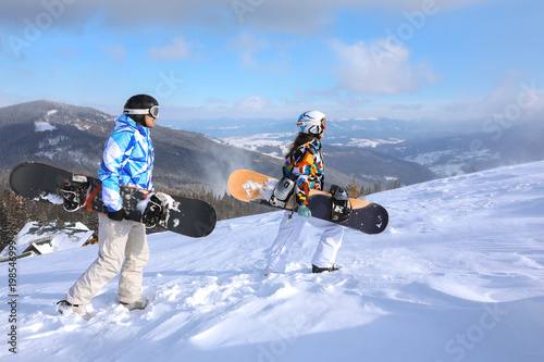 Couple with snowboards on s...