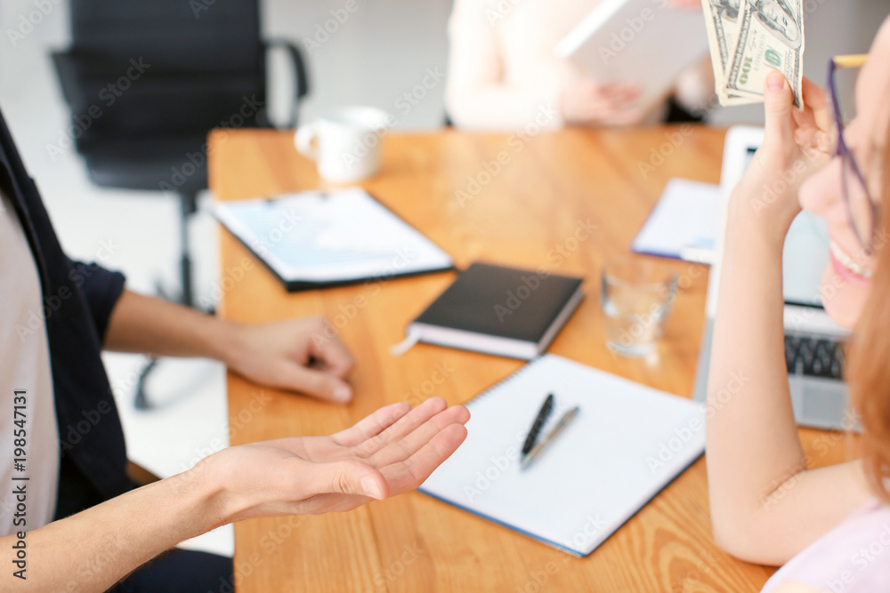 Woman giving money to man in office. Forex concept Woman giving money to man in office. Forex concept