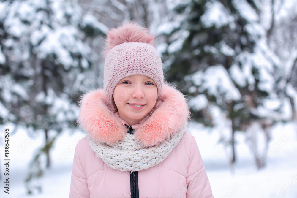 Cute girl in snowy park on winter vacation Cute girl in snowy park on winter vacation