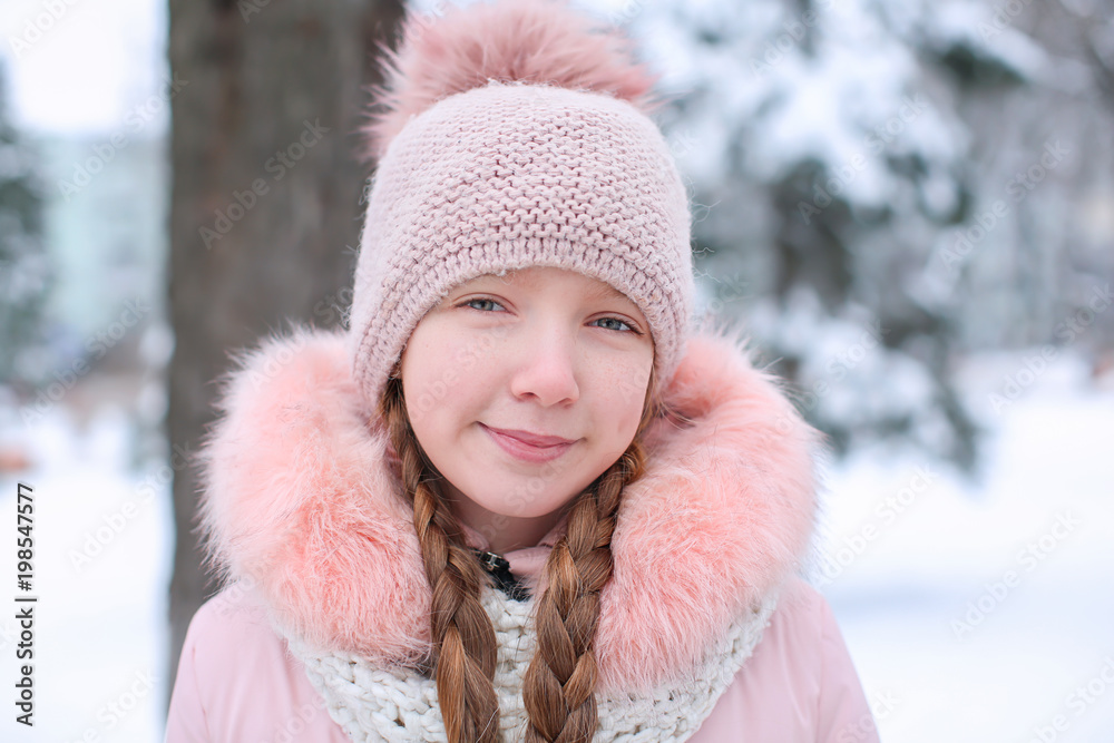 Cute girl in snowy park on winter vacation Cute girl in snowy park on winter vacation