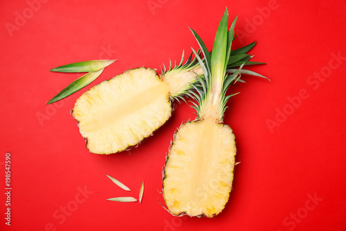 Fresh pineapple halves on color background