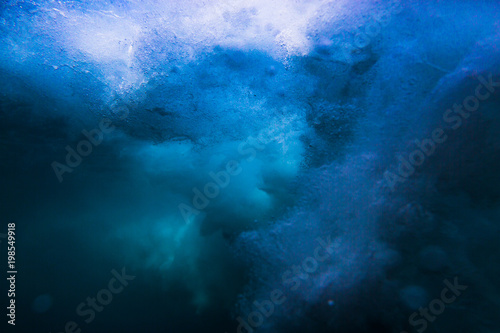 Wave underwater. Blue ocean in underwater