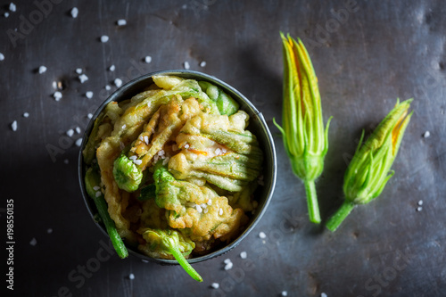 Homemade roasted zucchini flower served with salt