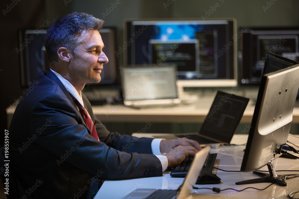 Businessman Working On Multiple Computers