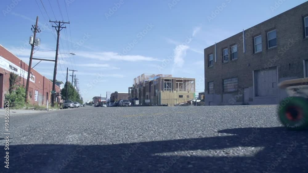 Millennial skateboarding asphalt street in neighborhood Millennial skateboarding asphalt street in neighborhood