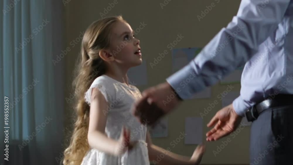 Daughter dancing with father at home, tender relations, spending time together Daughter dancing with father at home, tender relations, spending time together