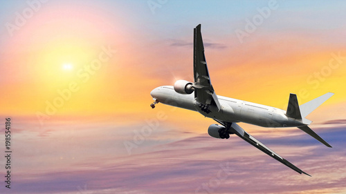 Commercial airplane flying above beautiful sky in dramatic sunlight.Travel and transportation concept.