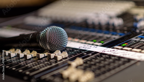 a mircophone resting on a digital mixing console photo