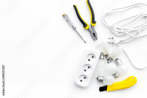 Electrical installation, wiring works. Tools and socket outlet on white background top view copy space