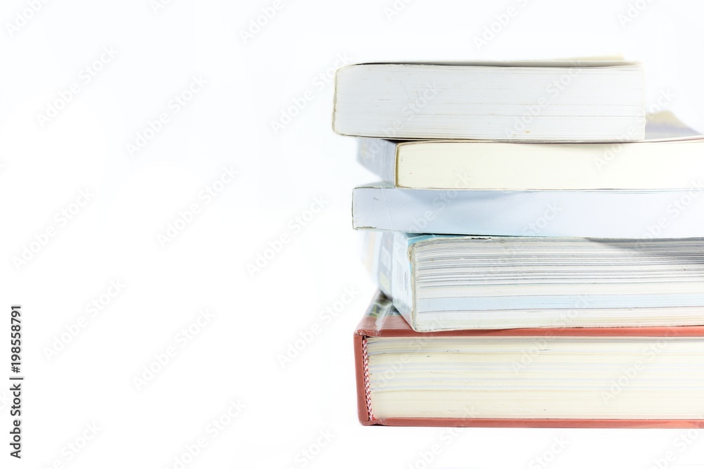 The pile of books over the stacking with many other books on a white background. The pile of books over the stacking with many other books on a white background.