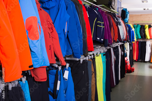 Diversity of ski clothes in store of sports equipment