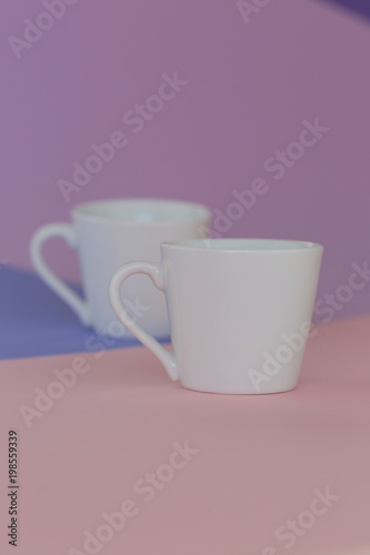 tableware mockup. Minimalist cup Mockup. Two white cups on a trendy graphic background in pastel colors.white cup on trend lilac pink graphic background. copy space