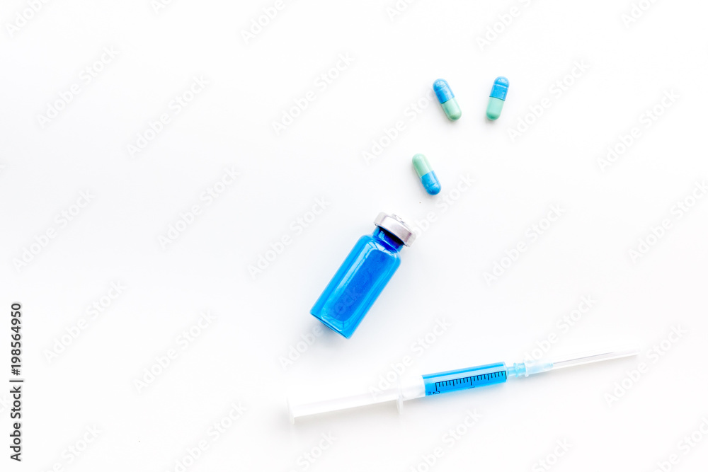 Syringe with medicine. Injection concept on white baclground top view copy space Syringe with medicine. Injection concept on white baclground top view copy space