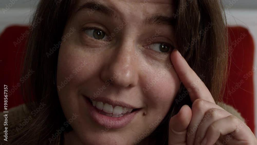 Woman making face showing a fake tear rolling down her cheek as she starts to laugh. Woman making face showing a fake tear rolling down her cheek as she starts to laugh.