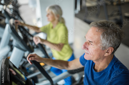 Senior man working out on stair stepper at gym © innervisionpro