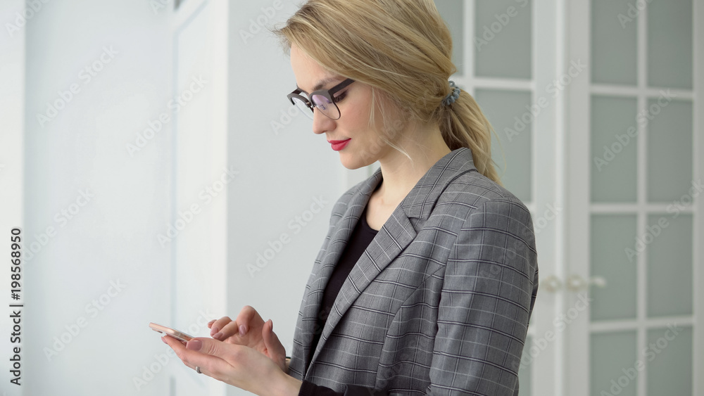 Portrait young businesswoman using smartphone holding mobile gadget, girl smile and texting message. Portrait young businesswoman using smartphone holding mobile gadget, girl smile and texting message.