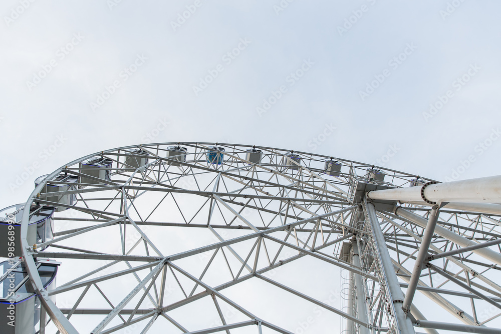 Ferris wheel on a summer day against a clear sky