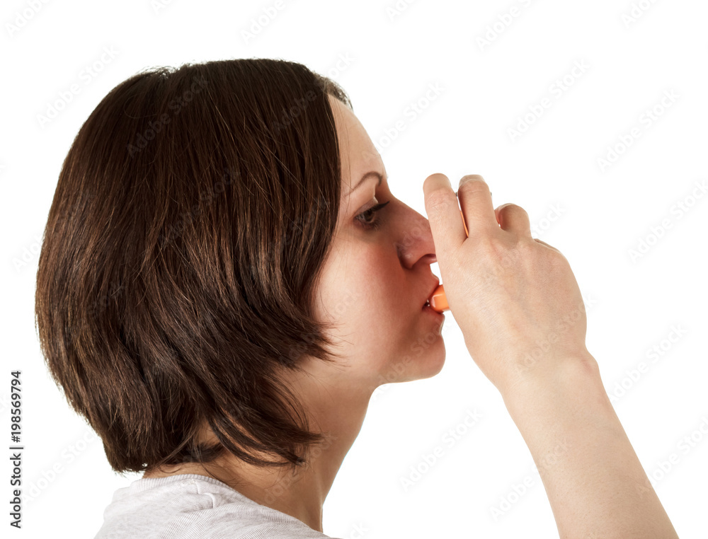 Small portable inhaler in woman hand isolated on white Small portable inhaler in woman hand isolated on white