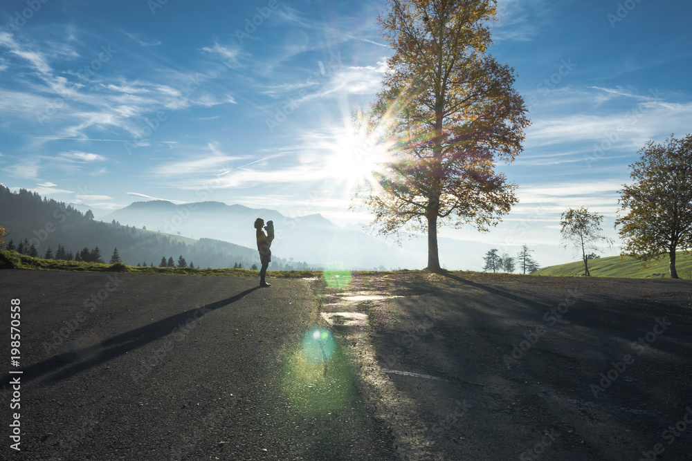 Obraz premium Silhouette of Woman Holding Baby in the Swiss Alps