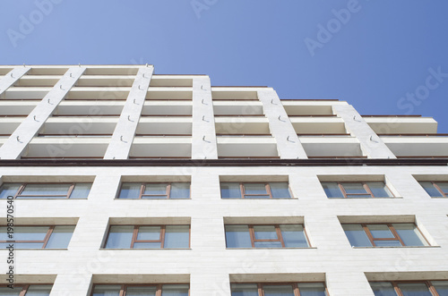 White facade of a business and home building with many windows