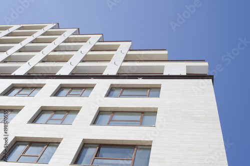 White facade of a business and home building with many windows