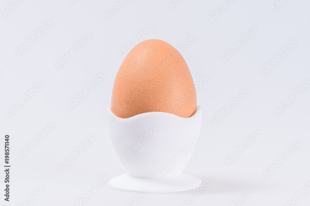 egg in egg Cup Brown, isolated on white background with space for text
