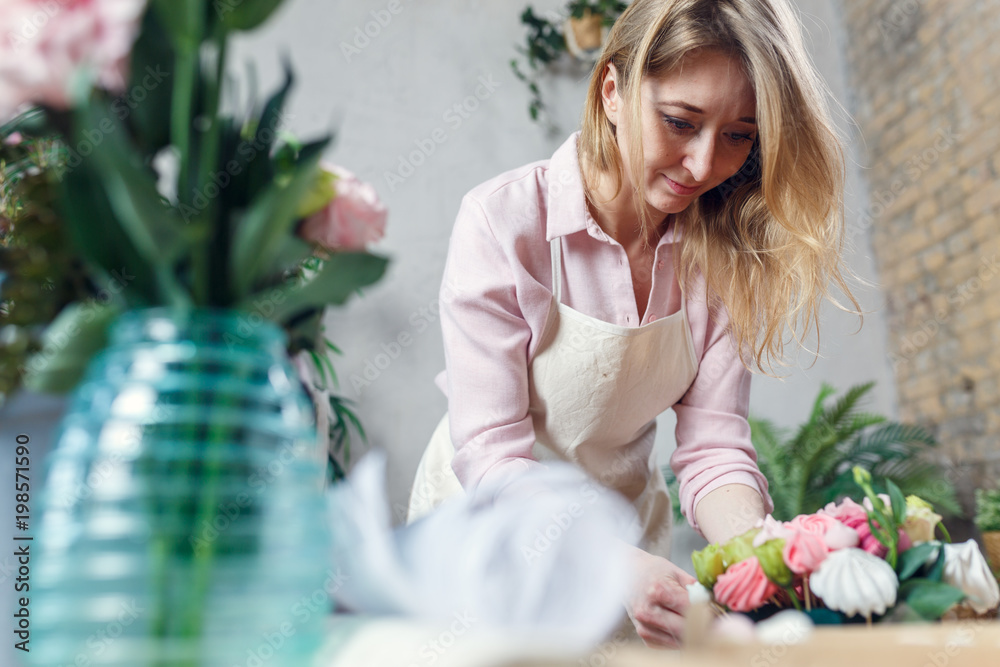 Photo of florist making bouquet at table Photo of florist making bouquet at table