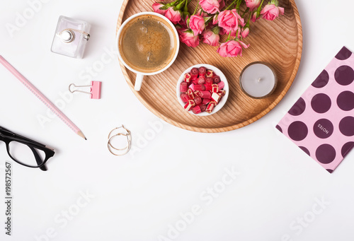 Feminine accessories, candies, coffee and roses on the white background,